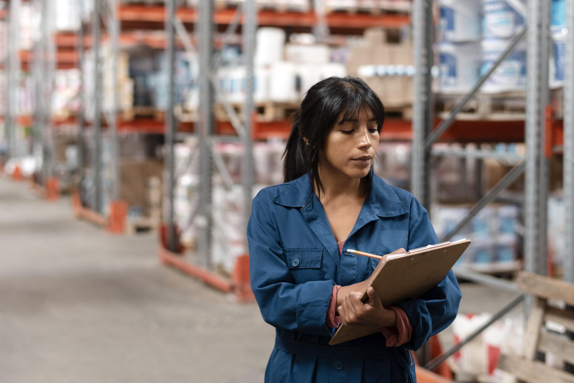 woman worker taking notes in a warehouse